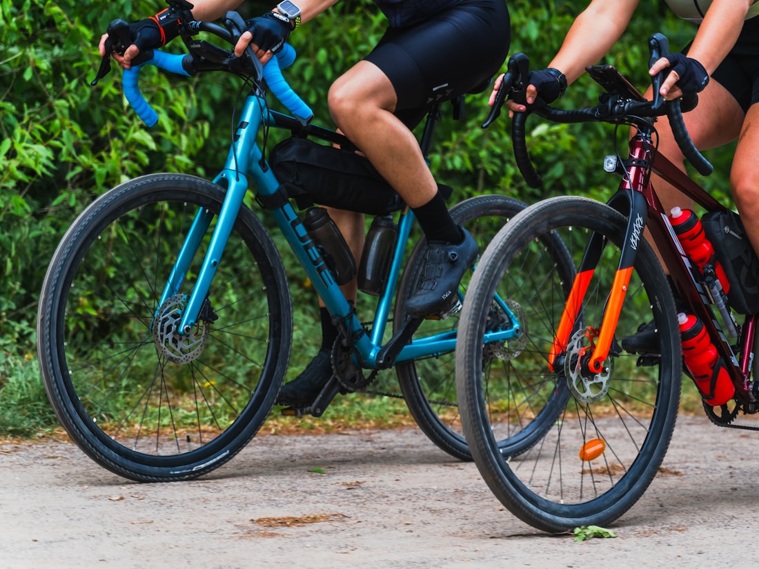 Cyclist riding a gravel bike on an unpaved trail