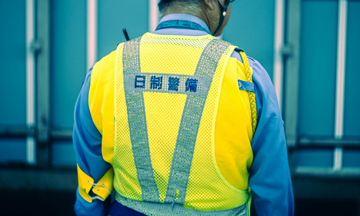 Road crew member in a fluorescent yellow long sleeve hi-vis work shirt with reflective tape