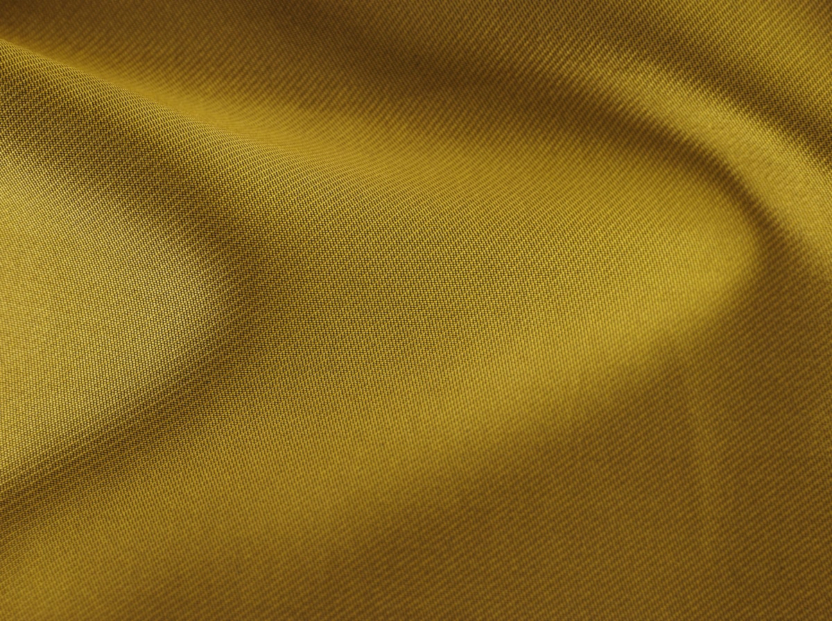 Macro of a brushed twill fabric draped into a soft curve