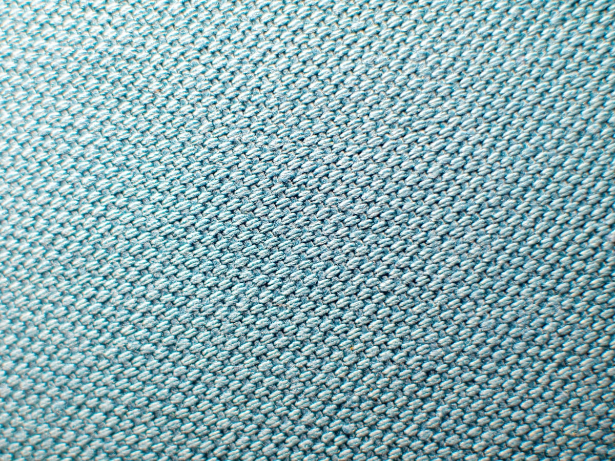 Dyed fabric held ready — standing colors exist as dyed fabric on the shelf before an order arrives