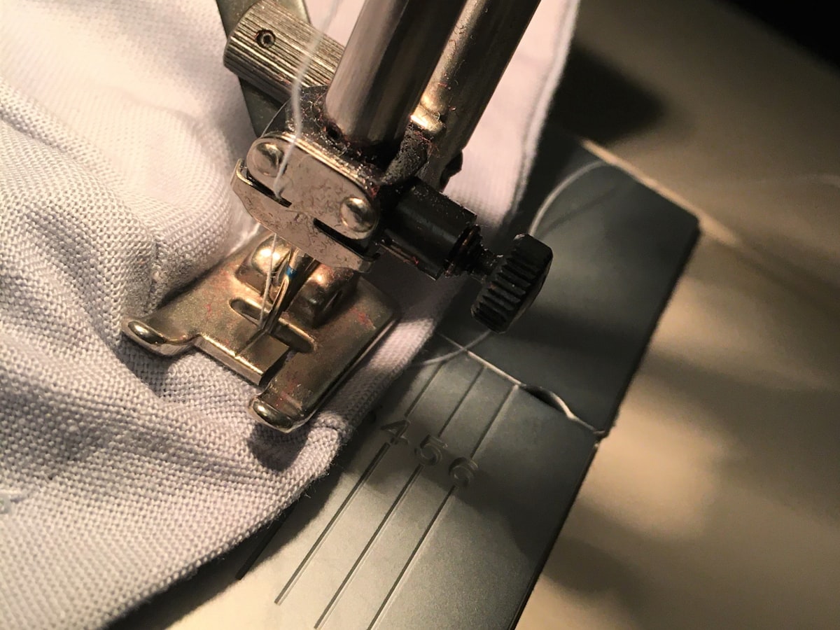 Sewing begins only after panels are cut from already-printed cloth