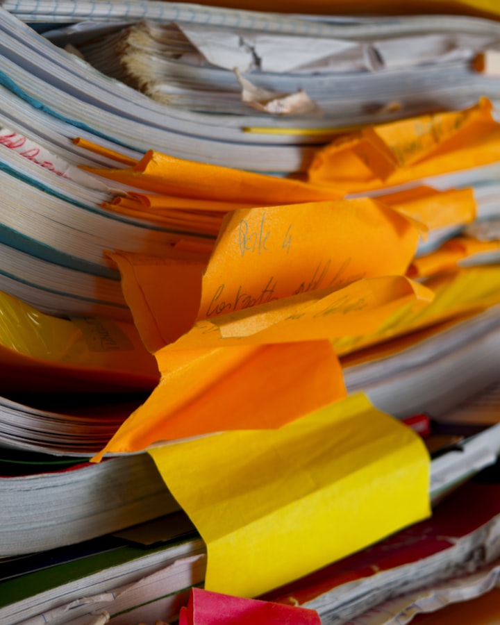 The retained order file: a stack of production documents with tabbed dividers holding patterns print files and the color reference, no readable brand names, no logos