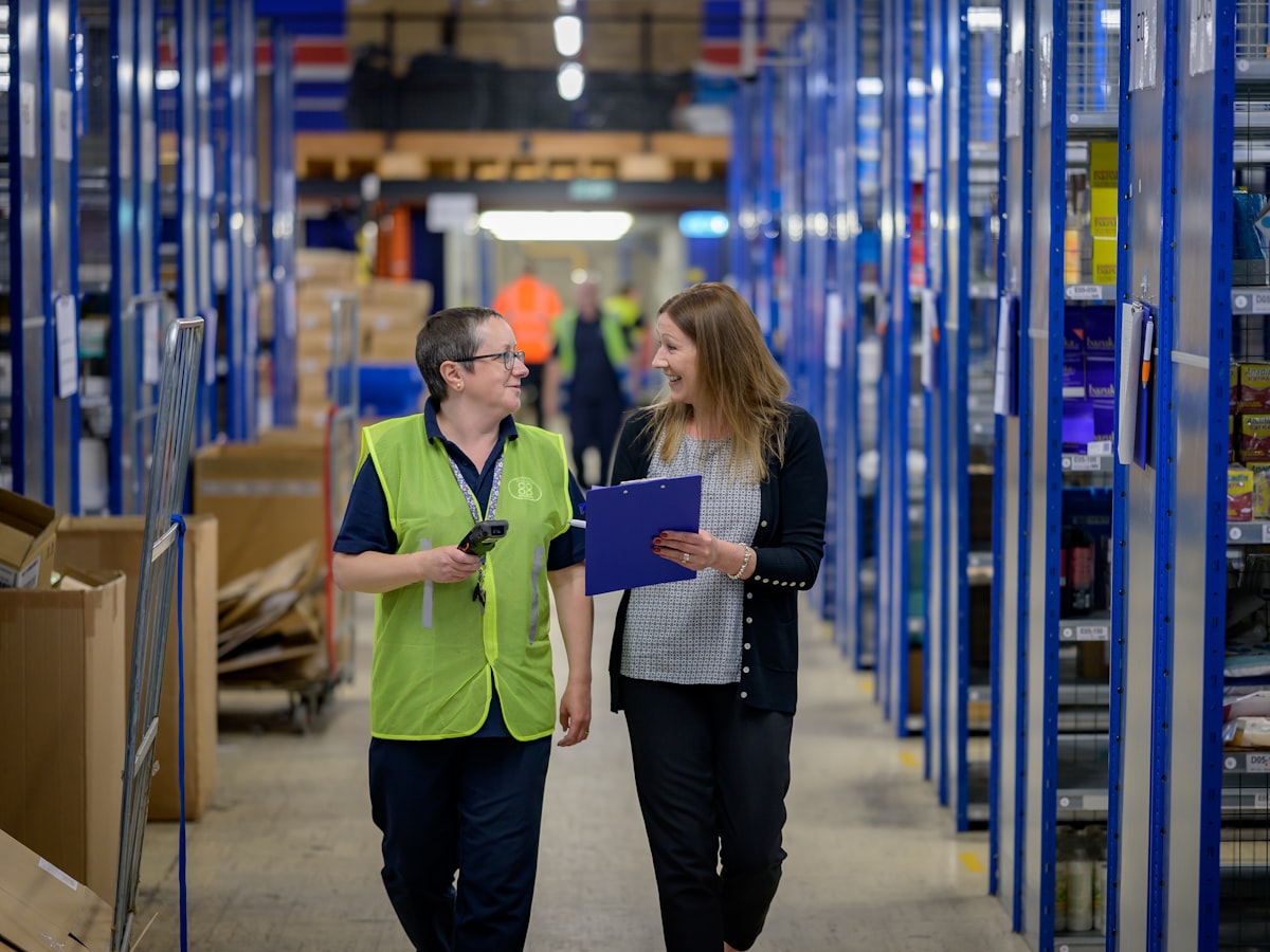 The account team walking the floor where finished orders are staged for shipment