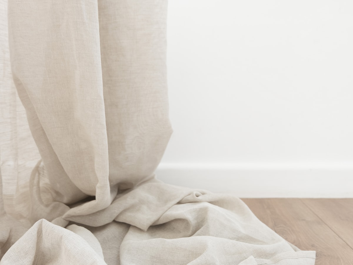 A light polyester base cloth — sublimated designs start from white or light fabric because dye adds color and cannot subtract it