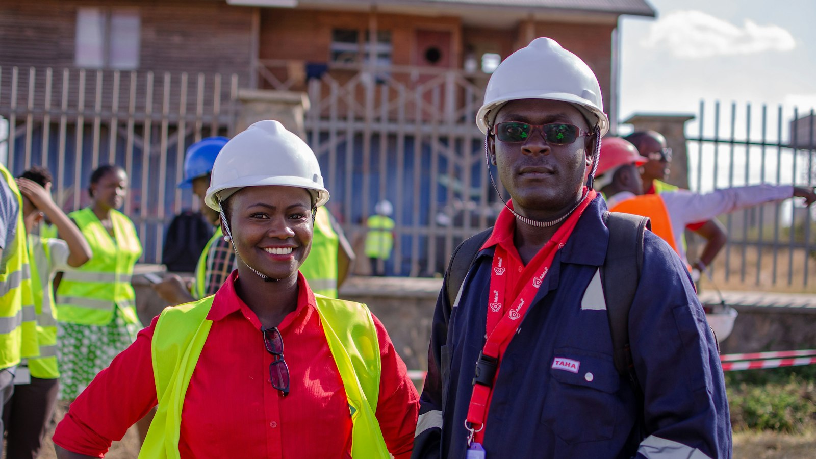 An HVAC technician, a warehouse lead and an embroidery shop owner, each wearing a different color work shirt with a fictional logo