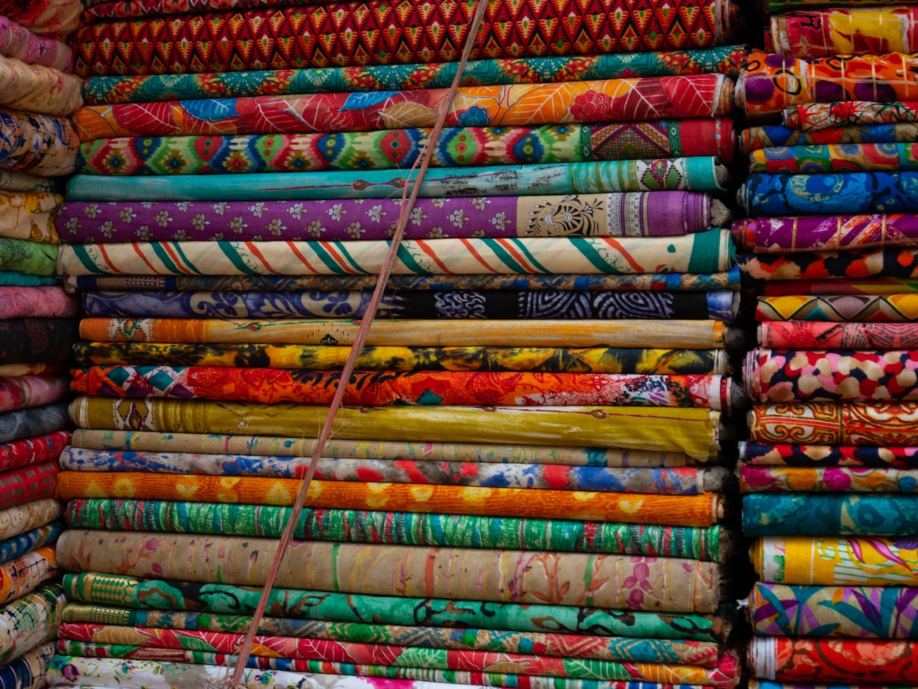 Printed fabric in varied colorways — one artwork system prints identically across a full size run