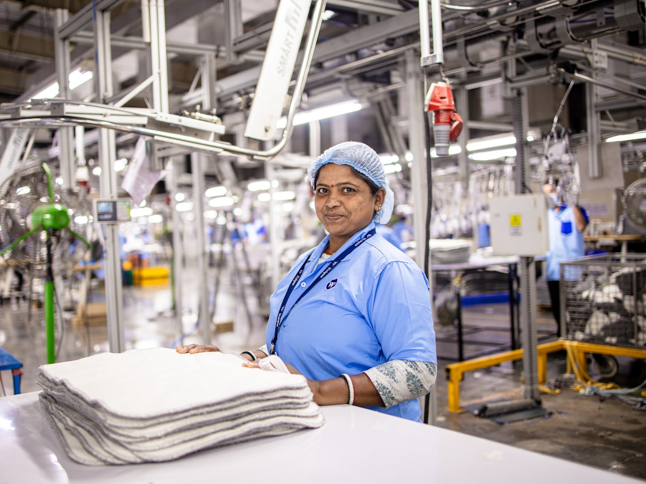 A worker finishing printed garments — decoration shops receive fully finished pieces with no step left in their own shop