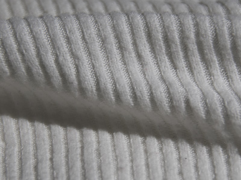 Close-up of a ribbed knit performance fabric structure built for rapid heat and moisture release