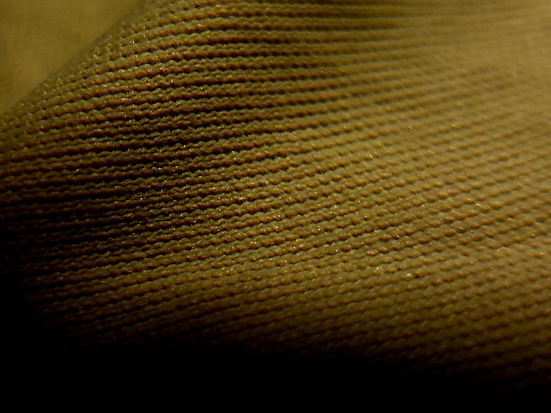 Close-up of a technical woven fabric structure, representing the hip and outer-thigh wear zone